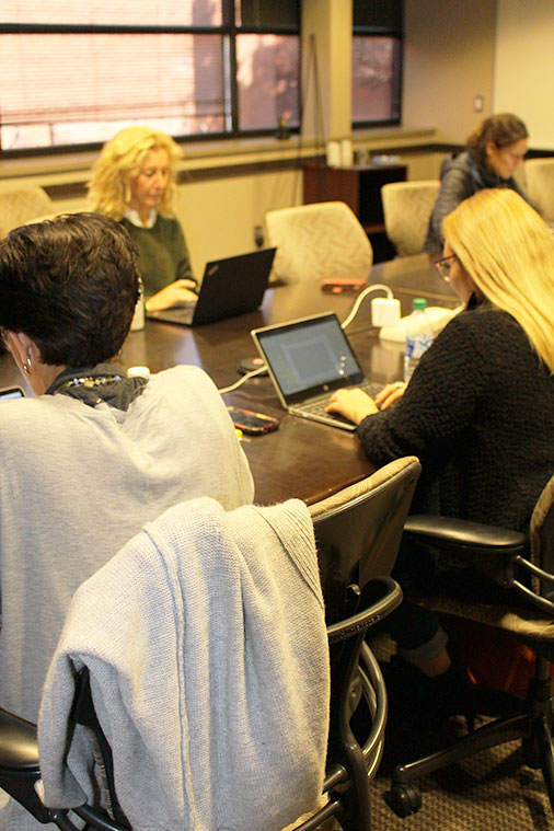 women writing on laptops