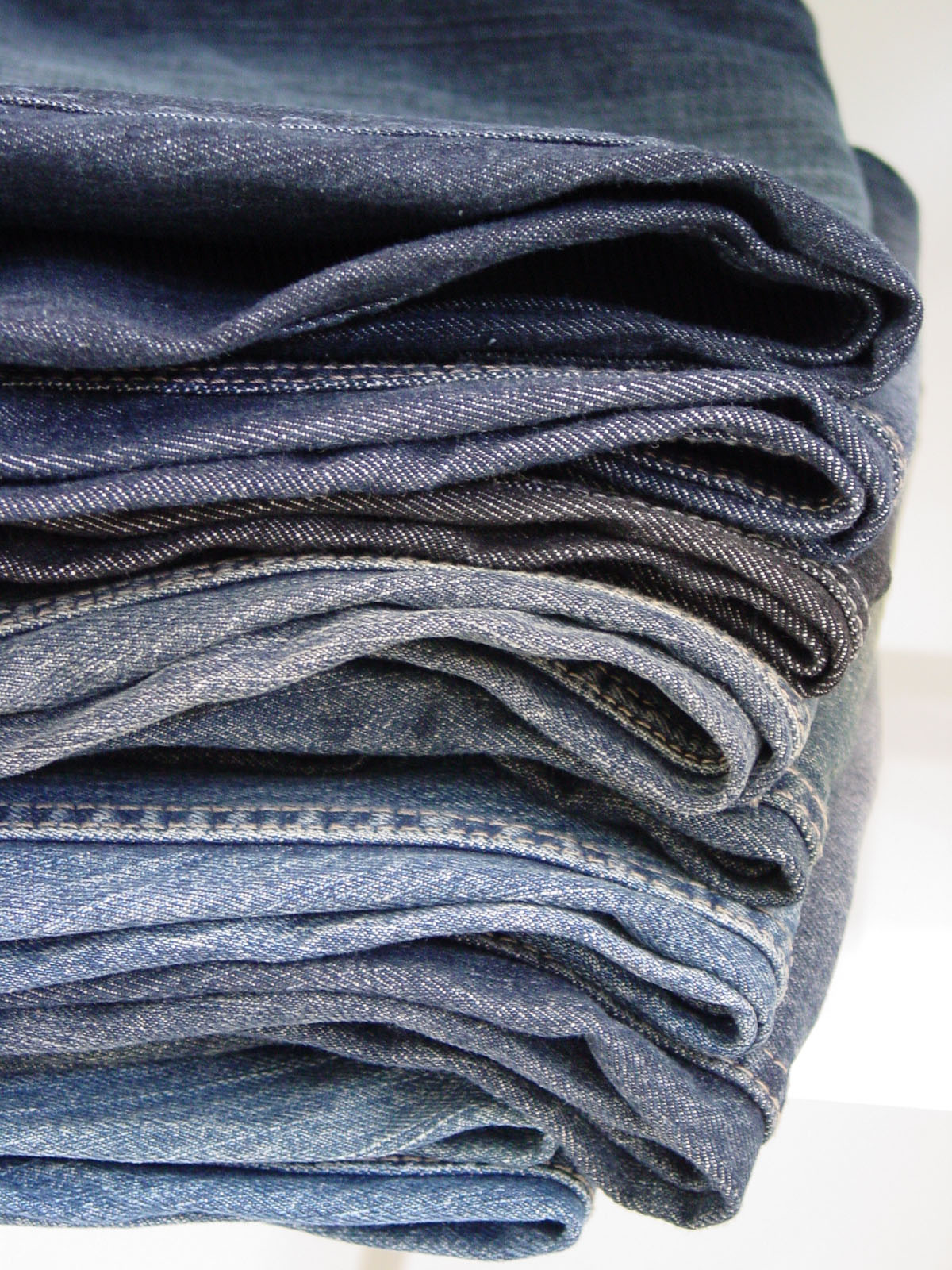 stack of denim jeans