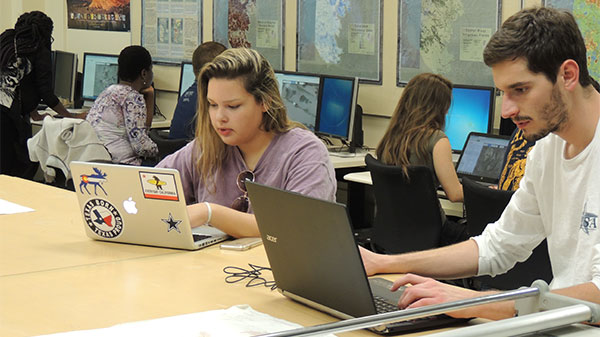 students at table working on maps