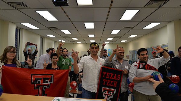 students holding texas tech signs