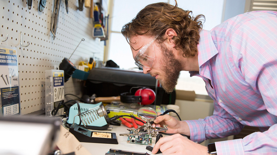 Gage Dutkin working on a microchip