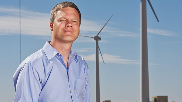 john schroeder in front of wind turbines