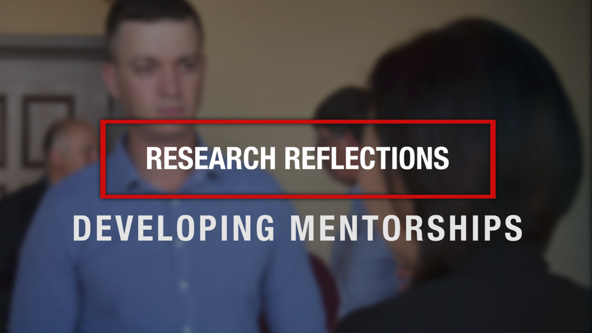 Text of "Research Reflections: Developing Mentorships" superimposed over an image of two researchers talking at a networking event.