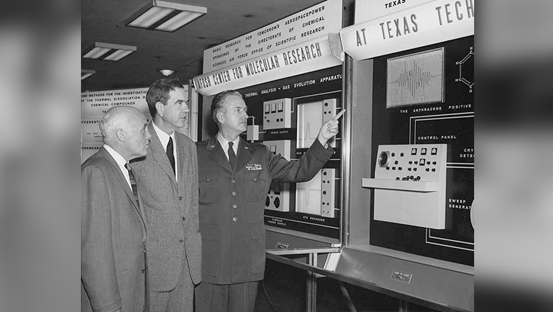 Air Force Secretary Eugene Zuckert, Congressman George Mahon and Colonel Jack L. Deets, executive director of the Air Force Office of Scientific Research discuss an exhibit titled “AFUSA Center for Molecular Research at Texas Tech