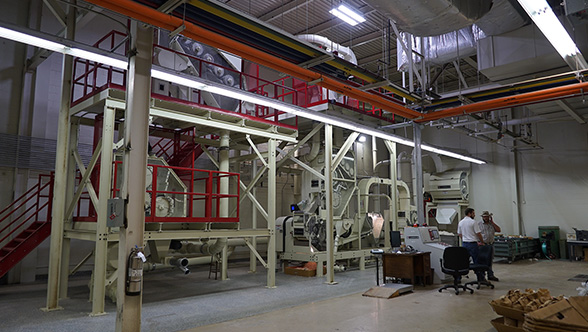 The FBRI's microgin is a fraction of the size of a standard cotton gin and has clear sides to better show how the cotton is processed through the machine.