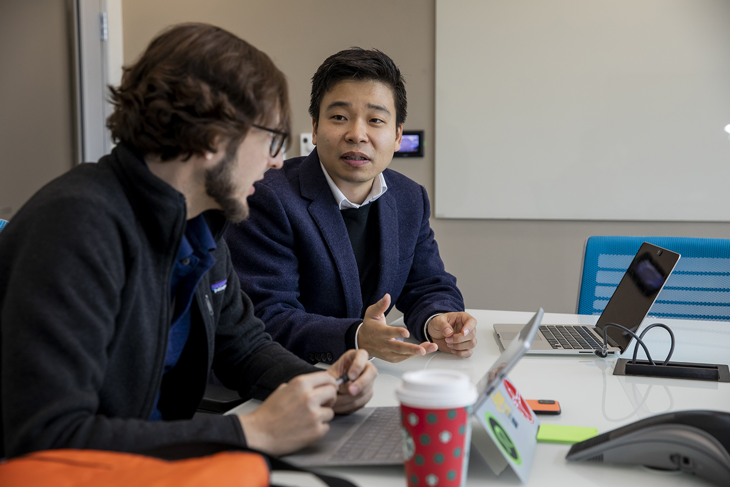 Jo Woon Chong (right) talks with mentor Nick Bergfeld (left)
