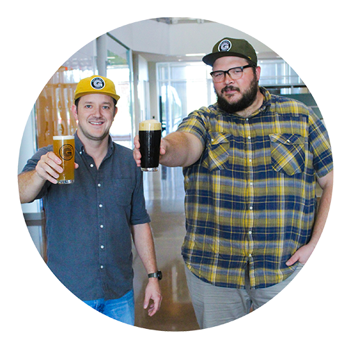 Good Line Beer Company co-founders Shawn Phillips (left) and Chris Troutman (right) hold glasses of beer at the Hub