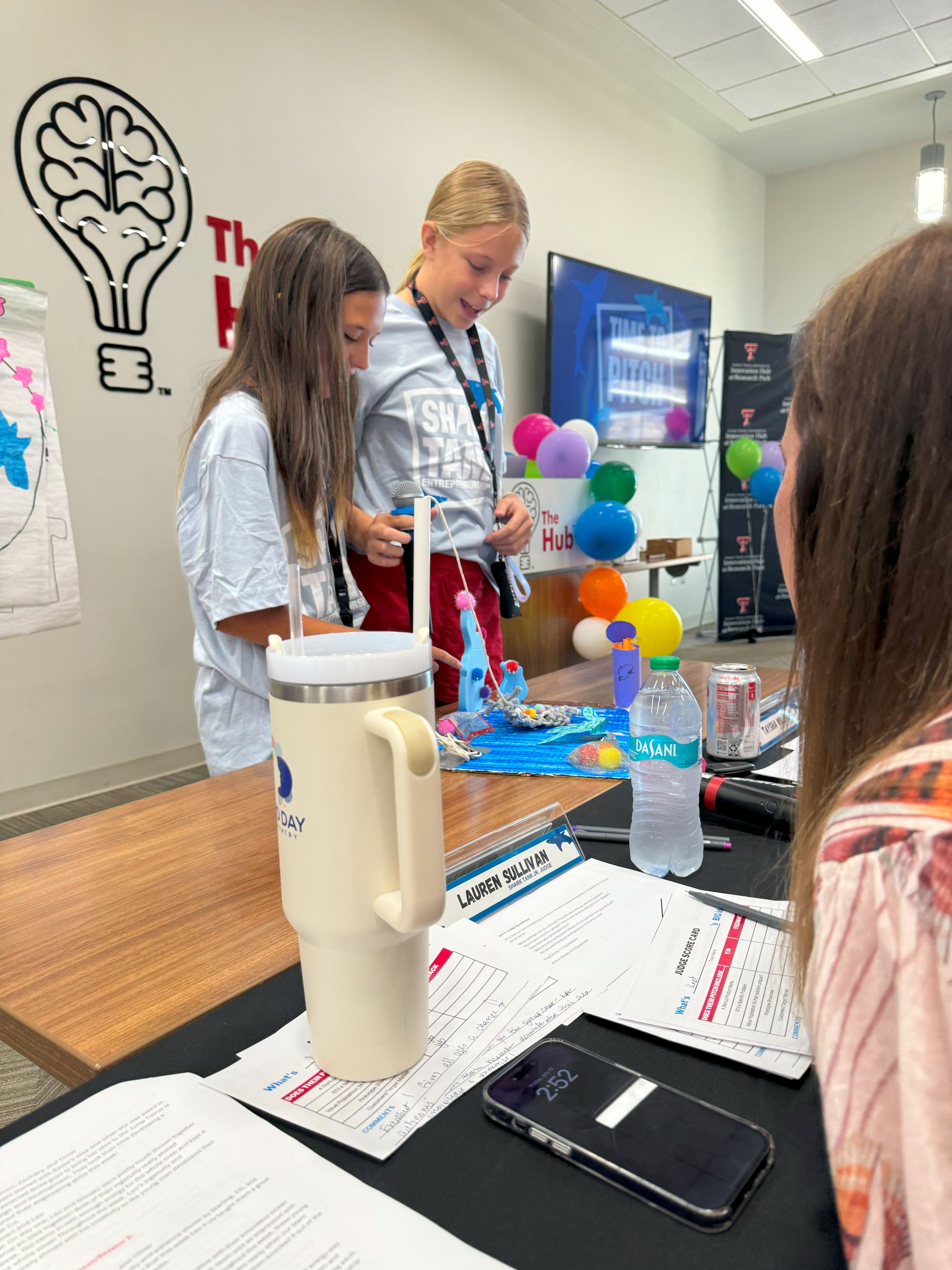 Girls presenting their idea and prototype to judges ("sharks") at Shark Tank Jr.
