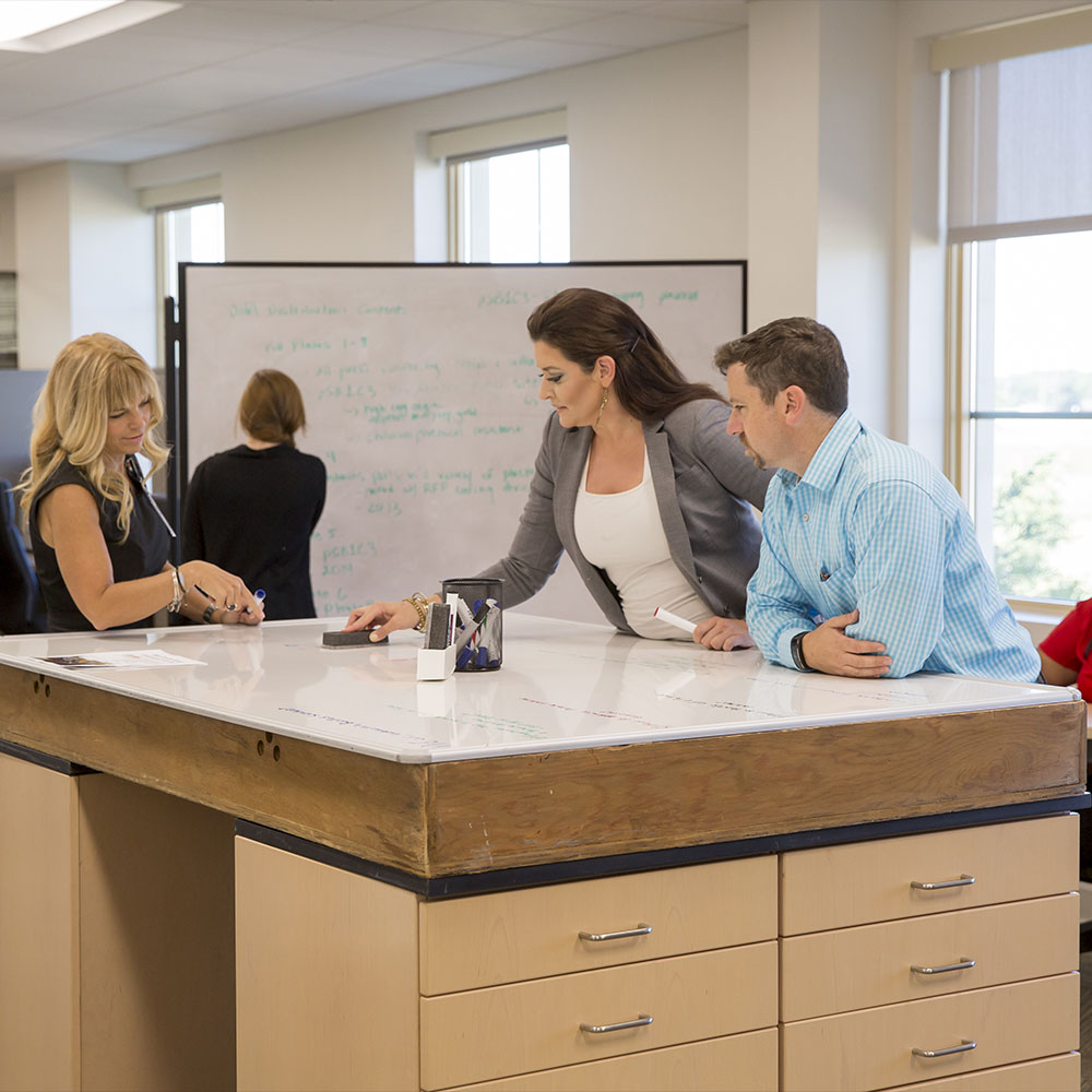 people at whiteboard desk