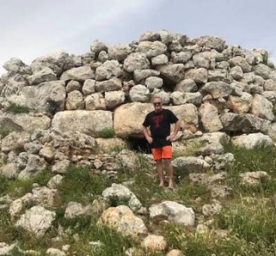 In front of Talaiotic (1,0000 BCE) structure on the island of Menorca (Spain)