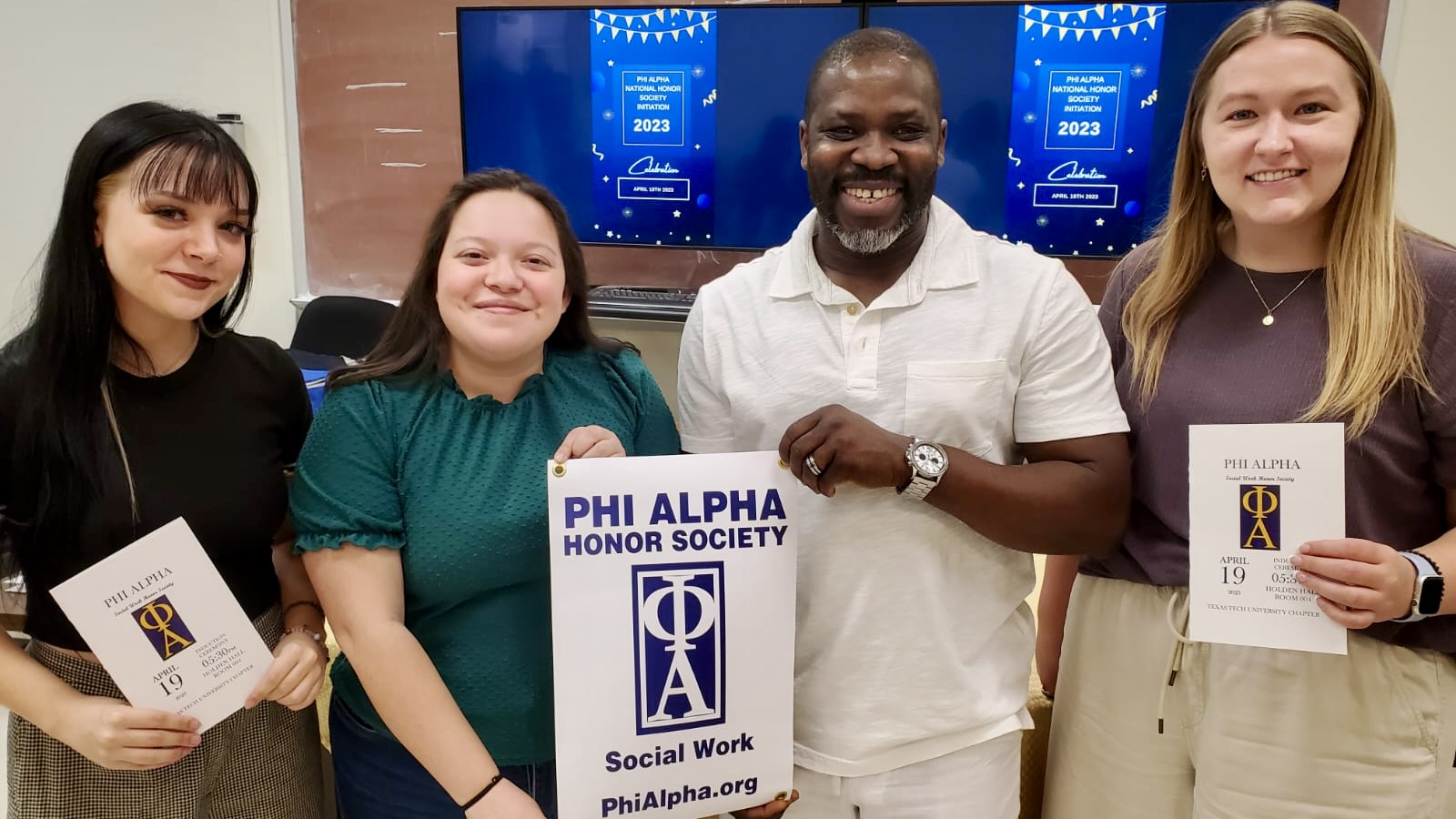 4 students pictured with "Phi Alpa Honor Society" poster
