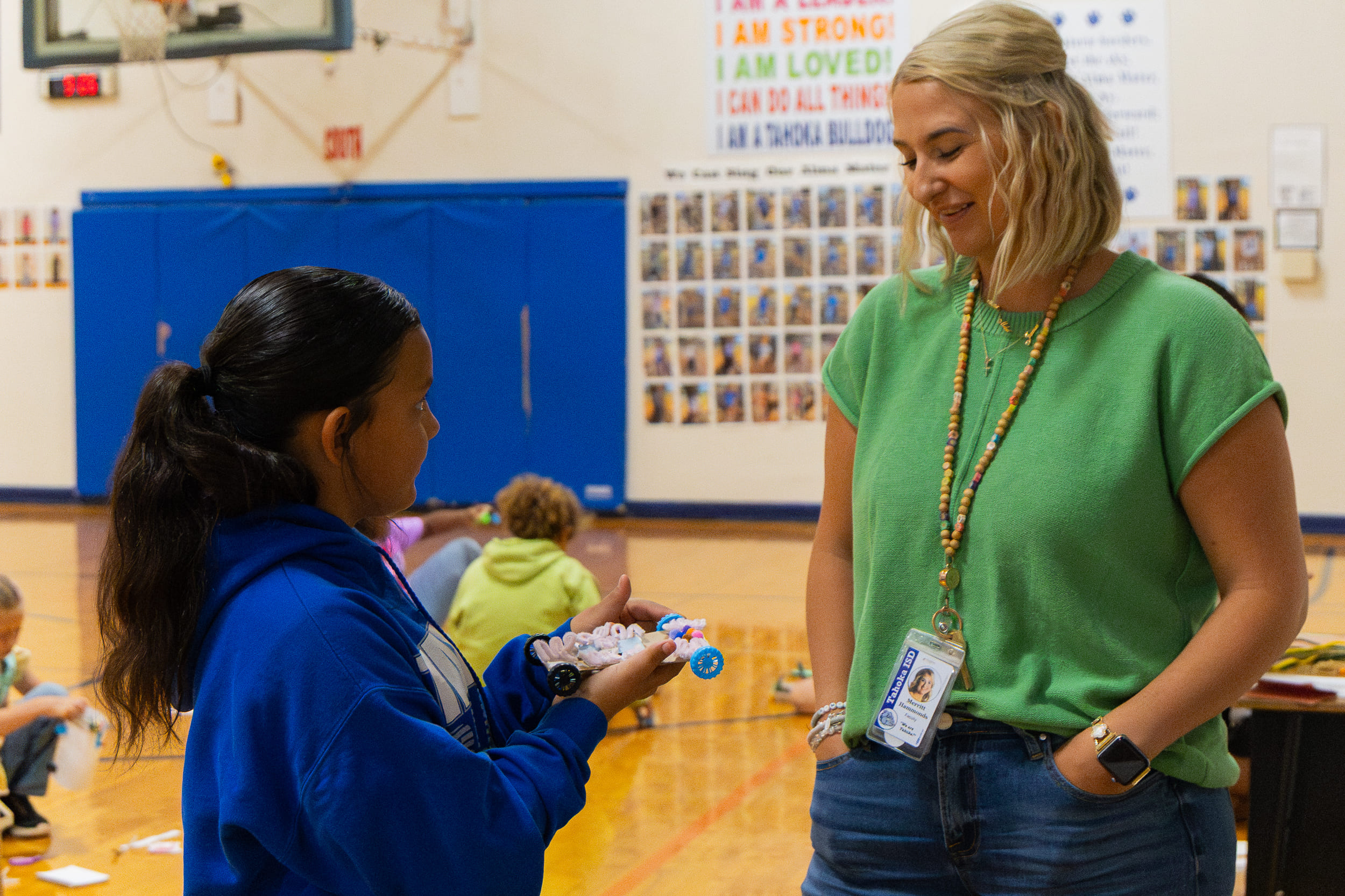 Teacher assisting student in activity