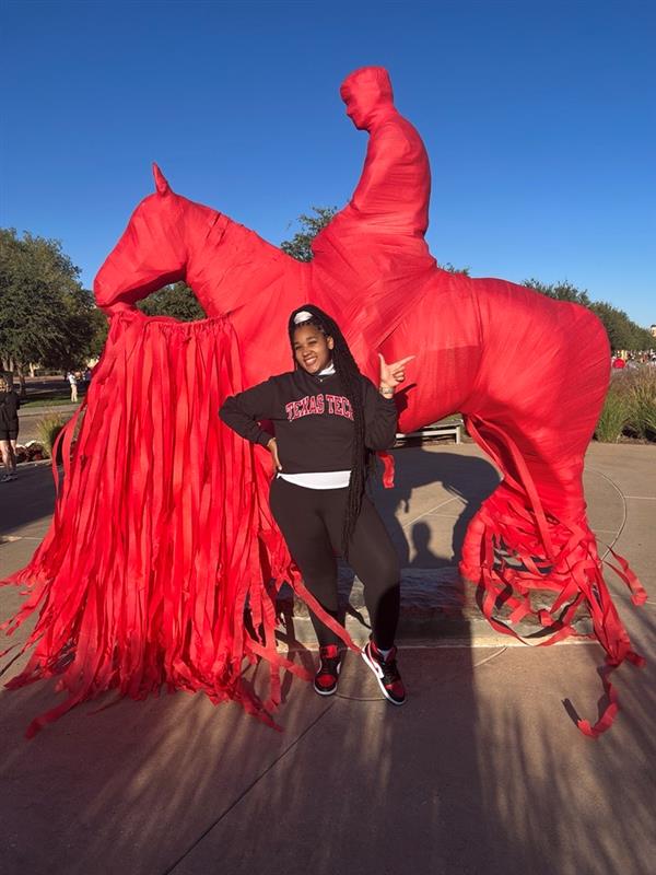 Chrislynne, Transfer Ambassador, poses on the Texas Tech Campus
