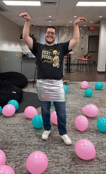 Gabe, Transfer Ambassador, attends a party in costume and with balloons