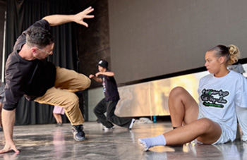 Male and female students practicing on-stage