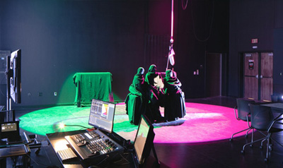 TTU students on a closed stage performing with different colored lights