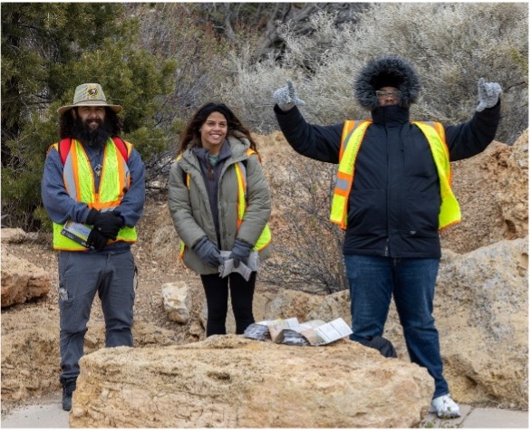 A group of people standing in front of rocks