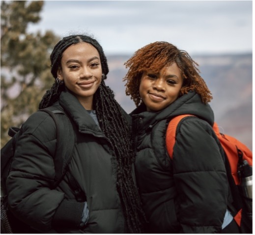 Two women standing together smiling