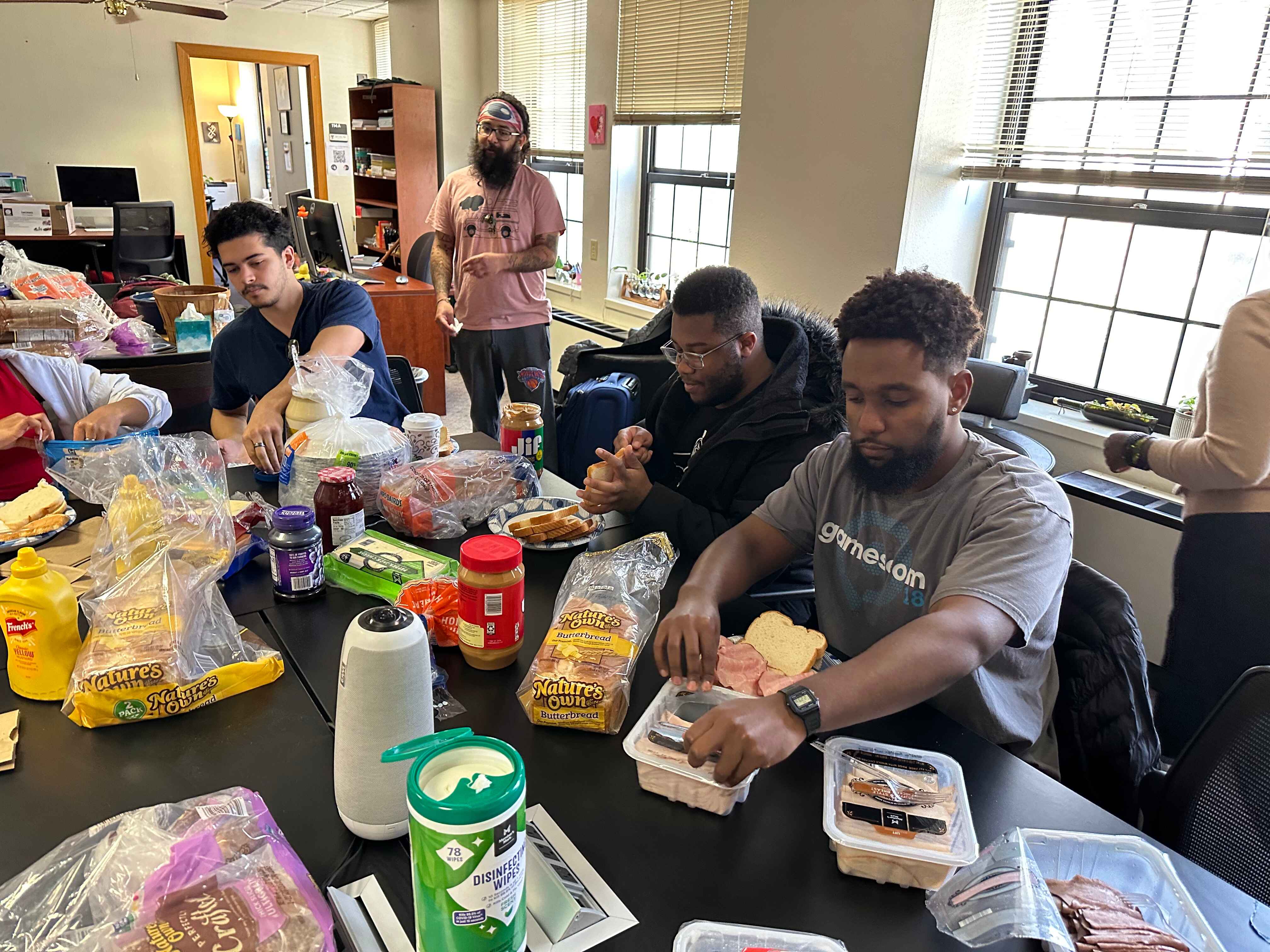 Group of people eating sitting at a table