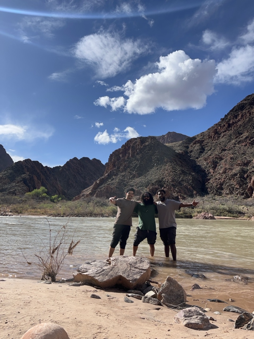 People standing beside a river
