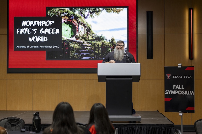 Man presenting at 2025 symposium