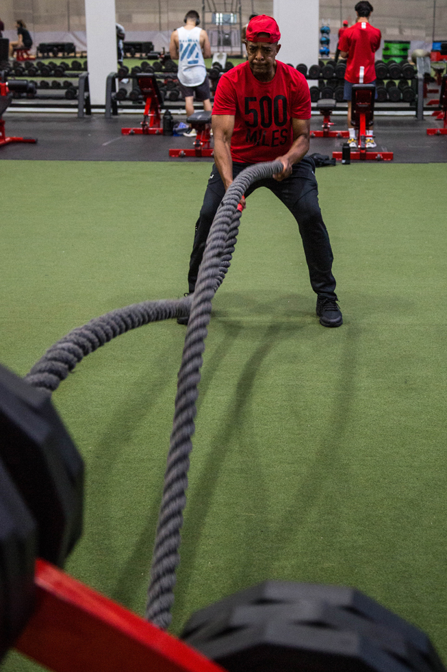 member doing battle ropes