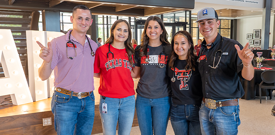 Five veterinary students looking into the camera