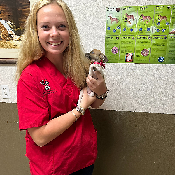 student holding dog