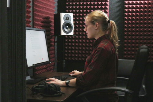 Student in front of a computer in a mixing studio