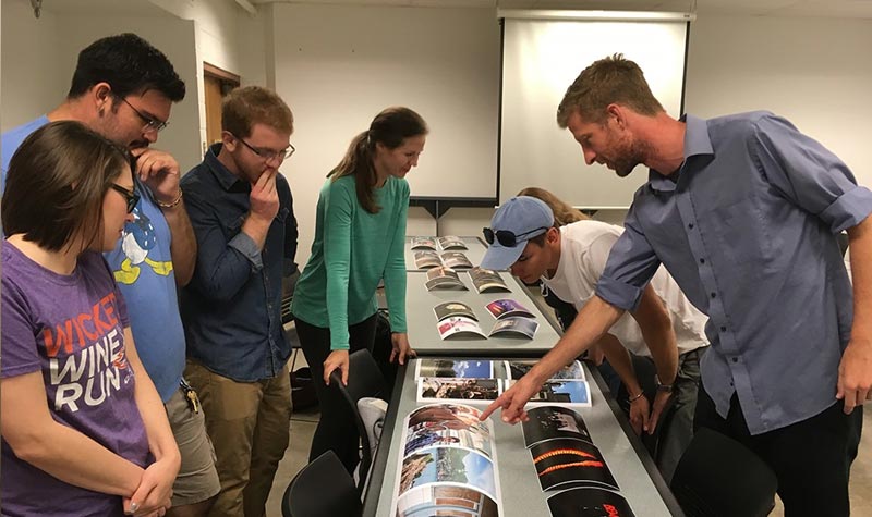 TCVPA students and faculty reviewing photographs visual performing arts