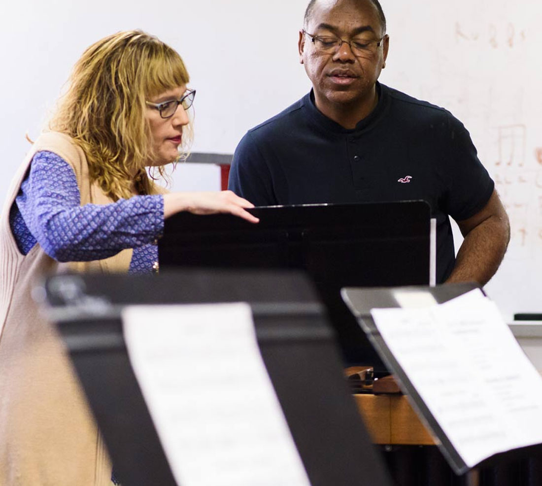 Music faculty working with student