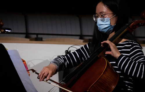 Student performing onstage with cello