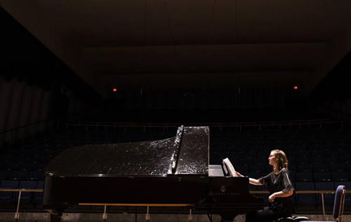 Piano student performing with piano on-stage