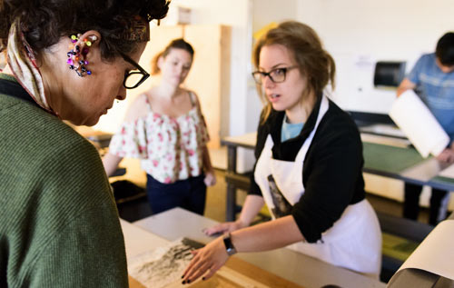 Faculty & students in an art classroom