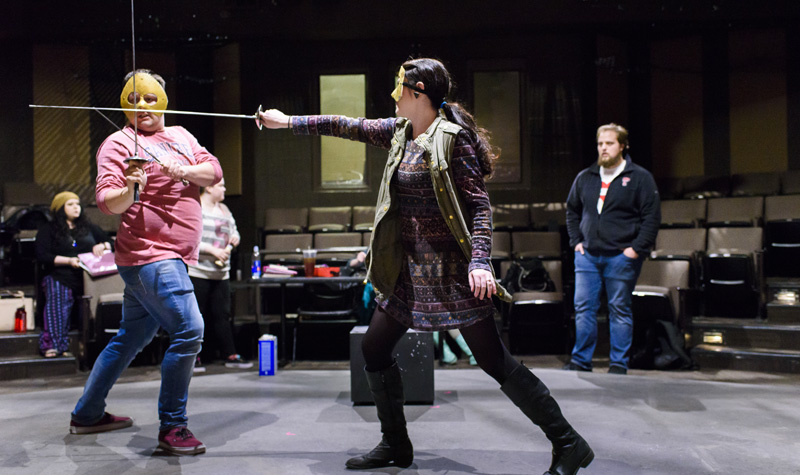 TTU theatre students having a mock sword fight