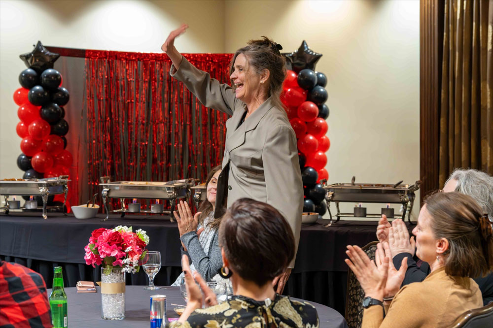 Carol Flueckiger, School of Art, accepting her 2024 RCAA Red award 