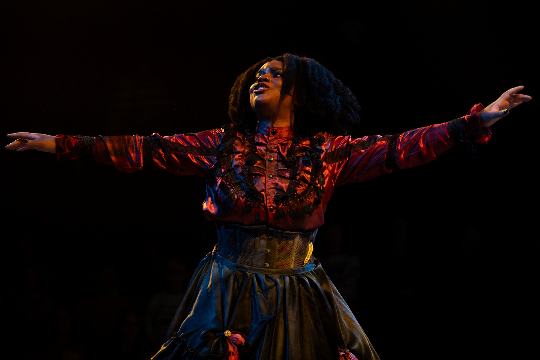 Naomi Shoshanna Taylor with outstretched arms as Lizzie Borde
