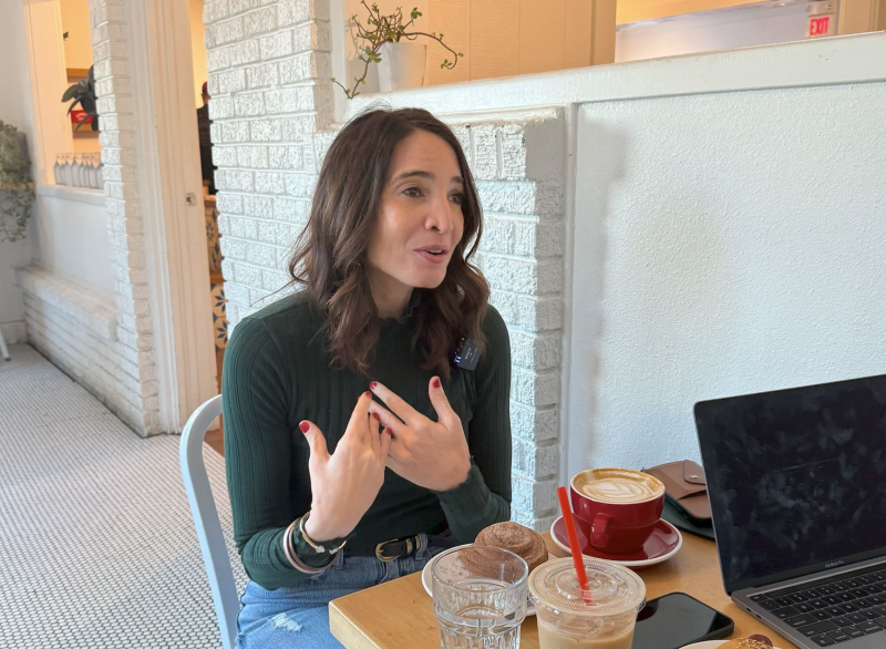 Sarai Brinker talking at a table with breakfast