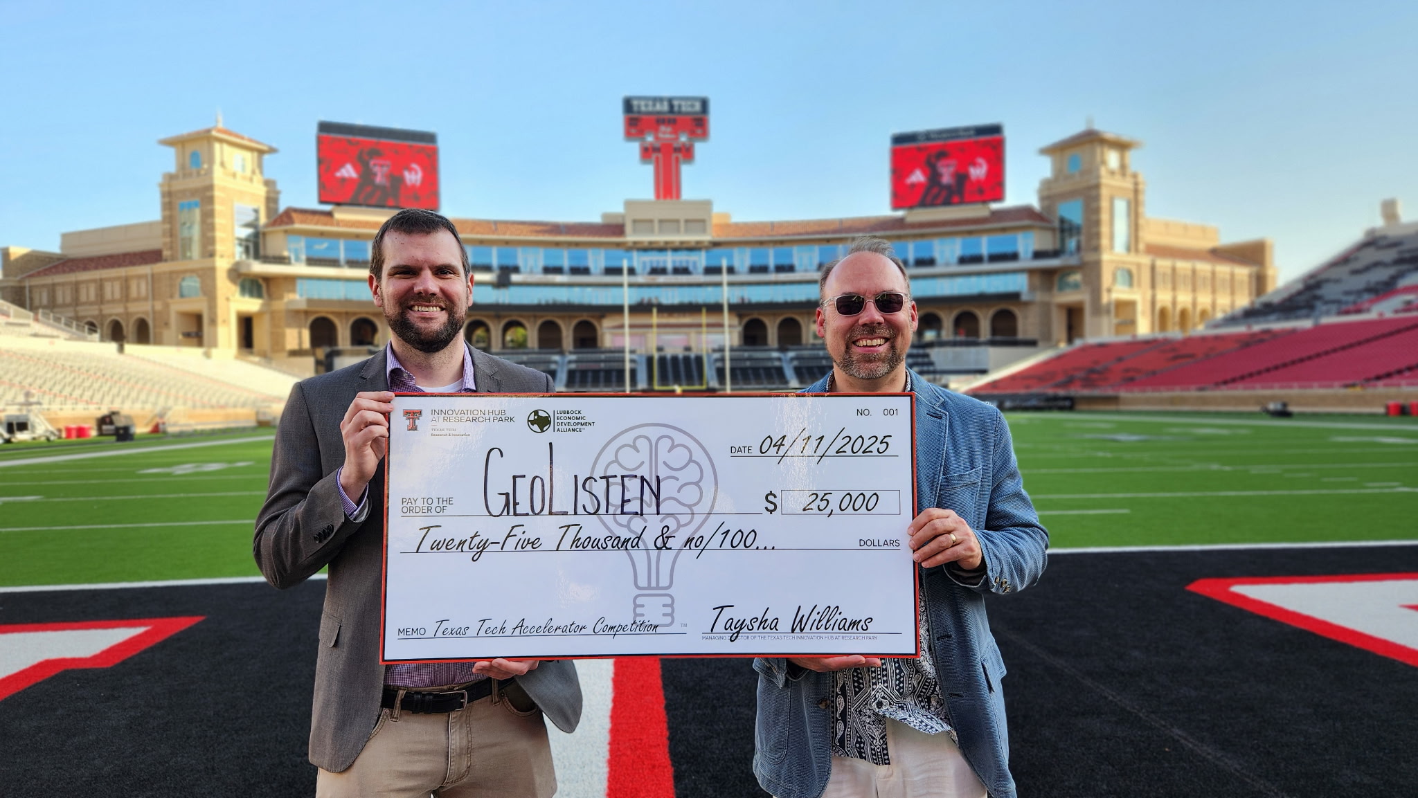 Davis Sears and Peter Martens holding large check