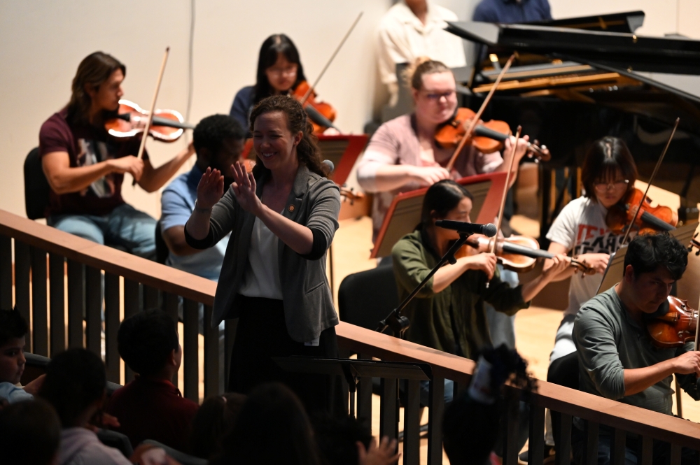 Mandy Algate conducting elementary school students at the All Together Symphony inside Hemmle Recital Hall.