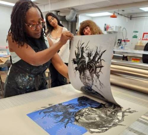 Pictured: Delita Martin reveals a newly pulled print during her residency at Texas Tech’s School of Art, where students observed each stage of her multi-process technique 